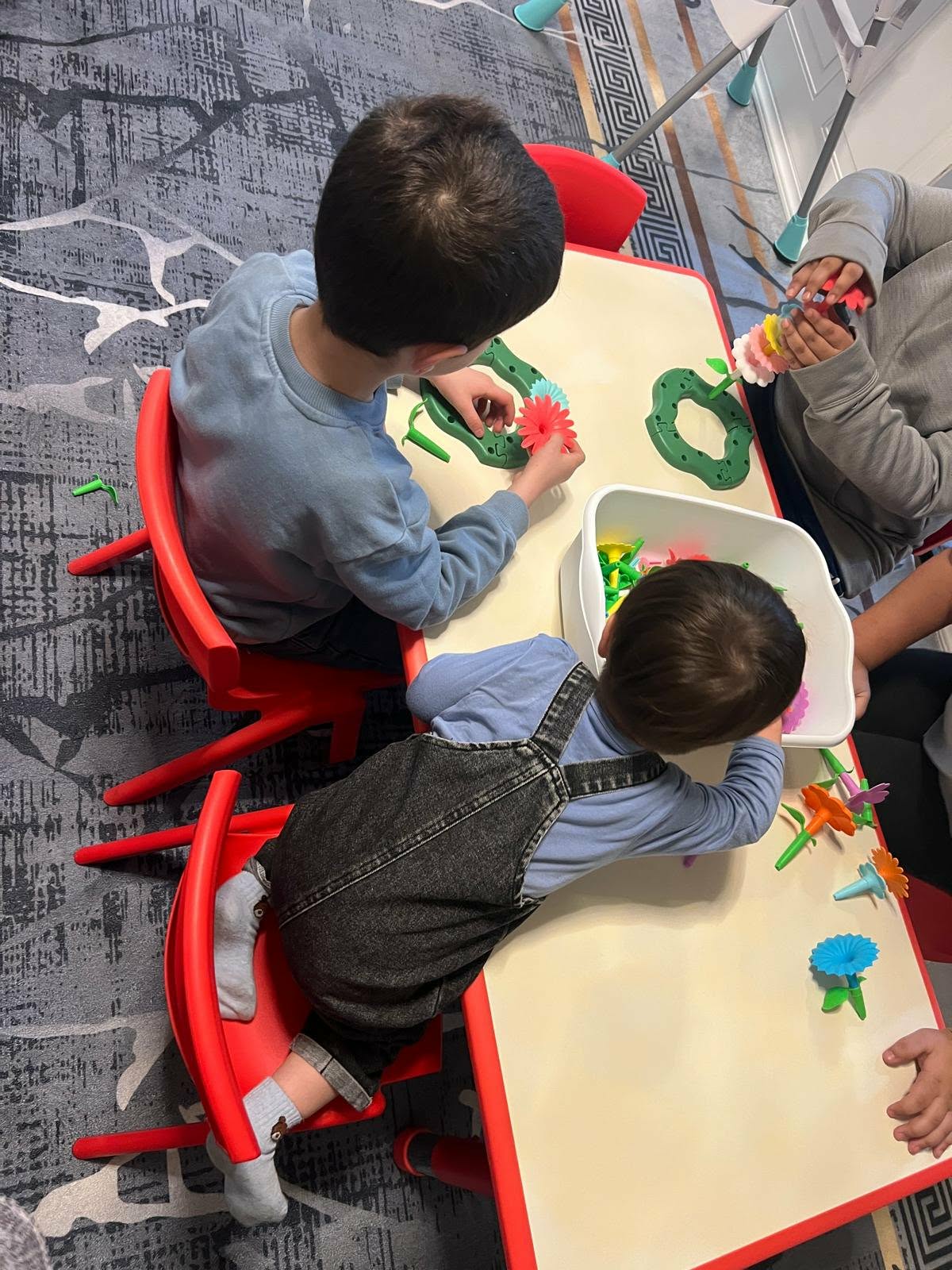 Kids building colorful flower towers at the activity table