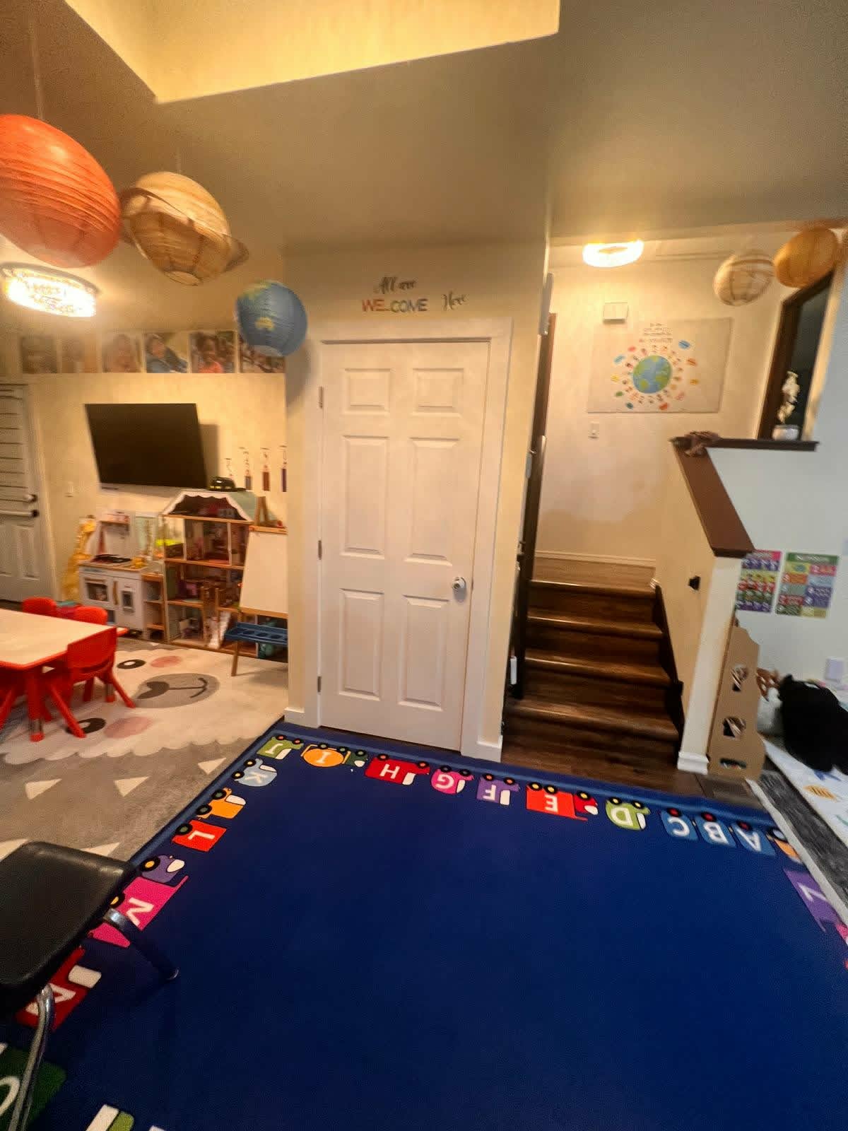 Main play area with ABC rug and play kitchen at WonderWorld Kids