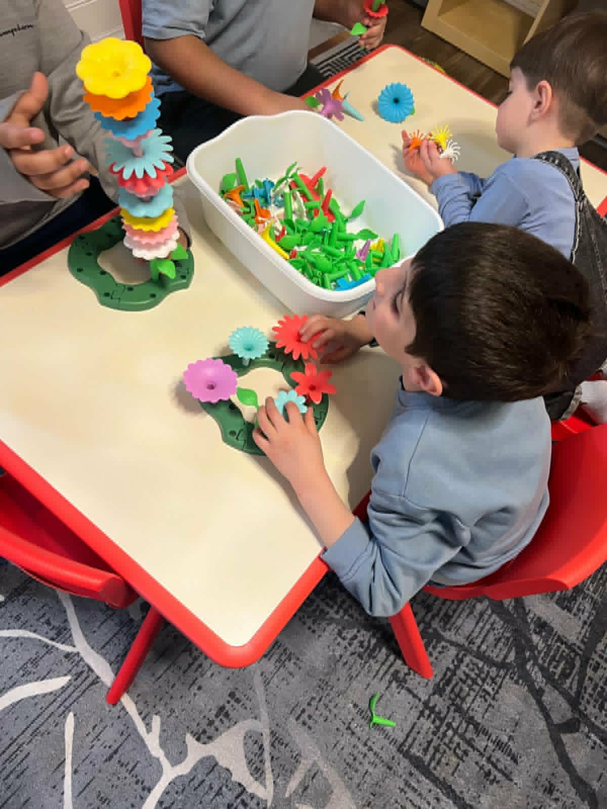 Child focused on building a tower at WonderWorld Kids